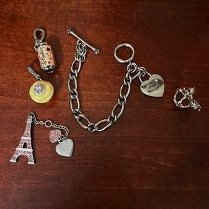 Juicy Couture bracelet with 4 charms. The Eiffel Tower does not have a clip.
